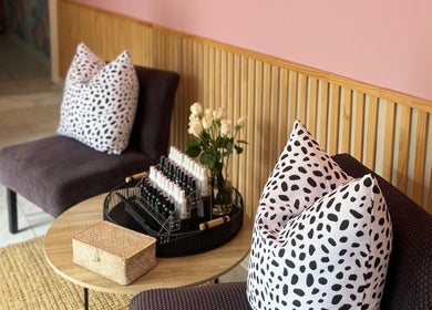 Chic seating with patterned pillows at BM Pressed, Westville, Kwazulu-natal, ZA. Inviting beauty and wellness ambiance.