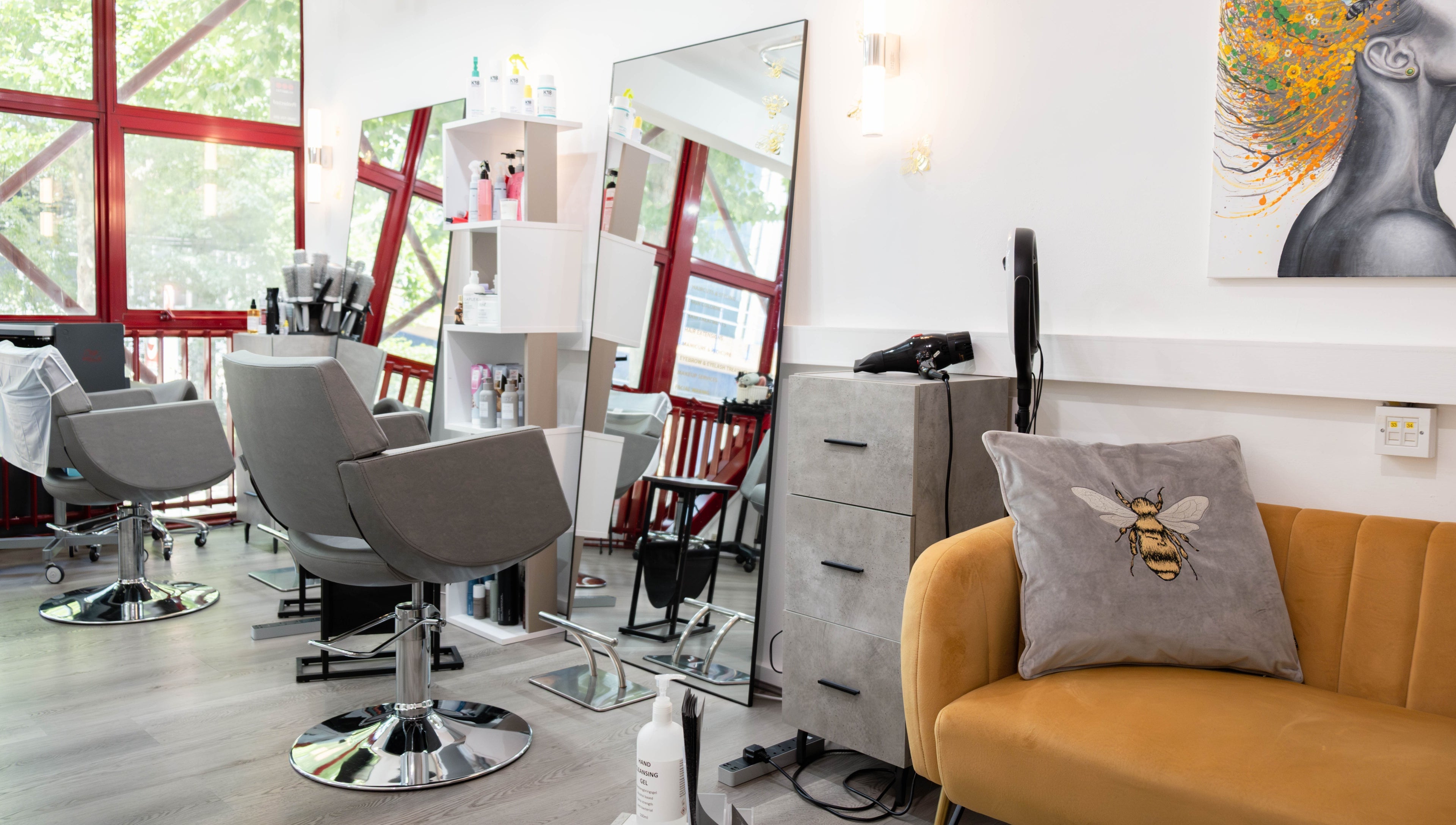 Modern salon interior at Hair Rituals by Ariana, London, England, GB with stylish chairs and decor.