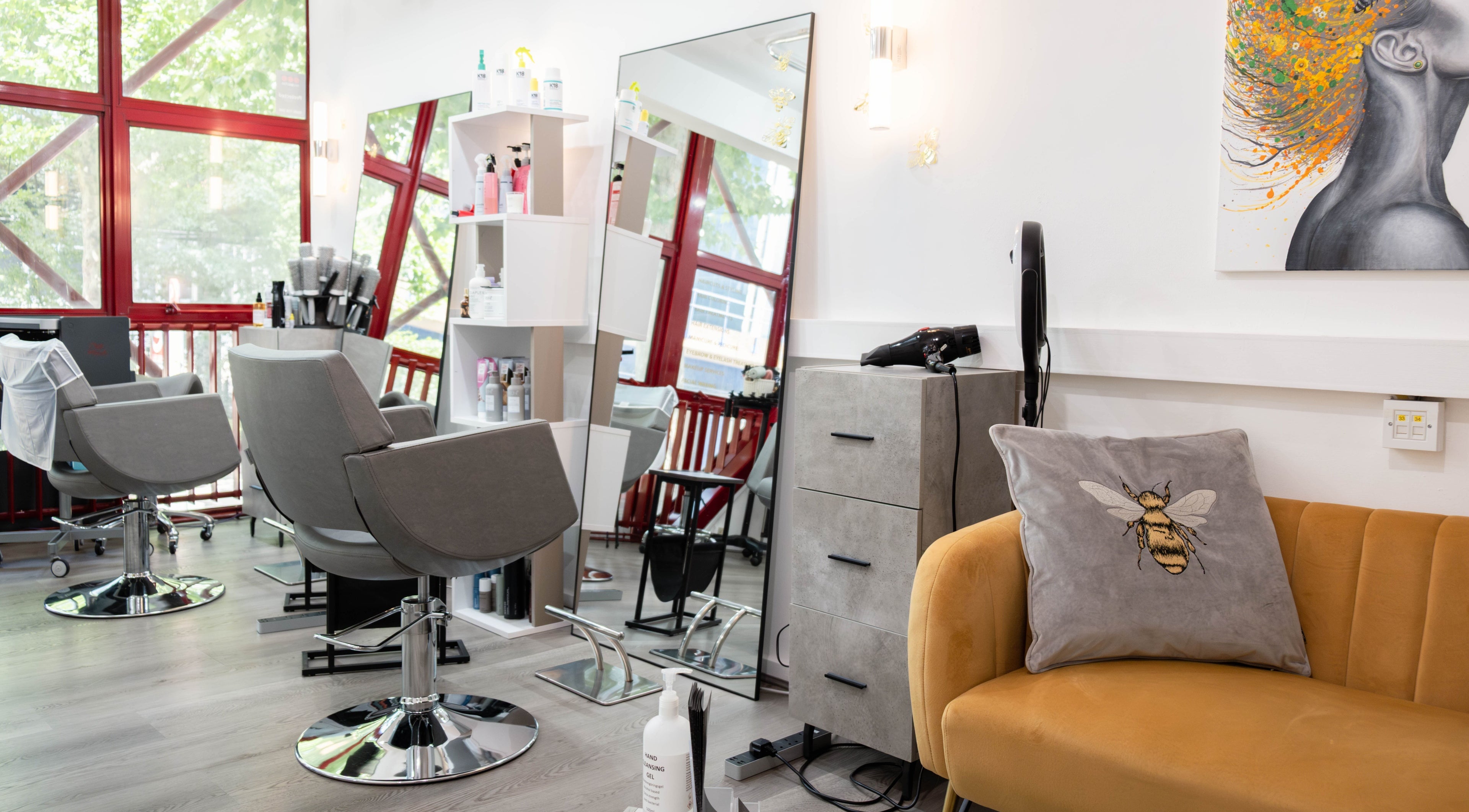 Modern salon interior at Hair Rituals by Ariana, London, England, GB with stylish chairs and decor.