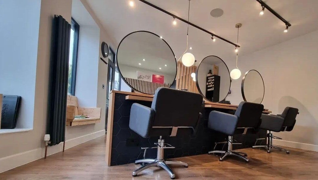 Modern salon interior at Onesixeight, Boston Spa, England, GB with stylish seating and mirrors.
