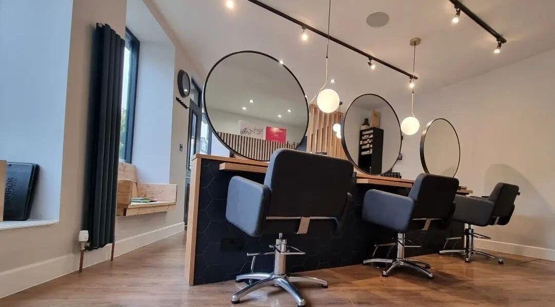 Modern salon interior at Onesixeight, Boston Spa, England, GB with stylish seating and mirrors.