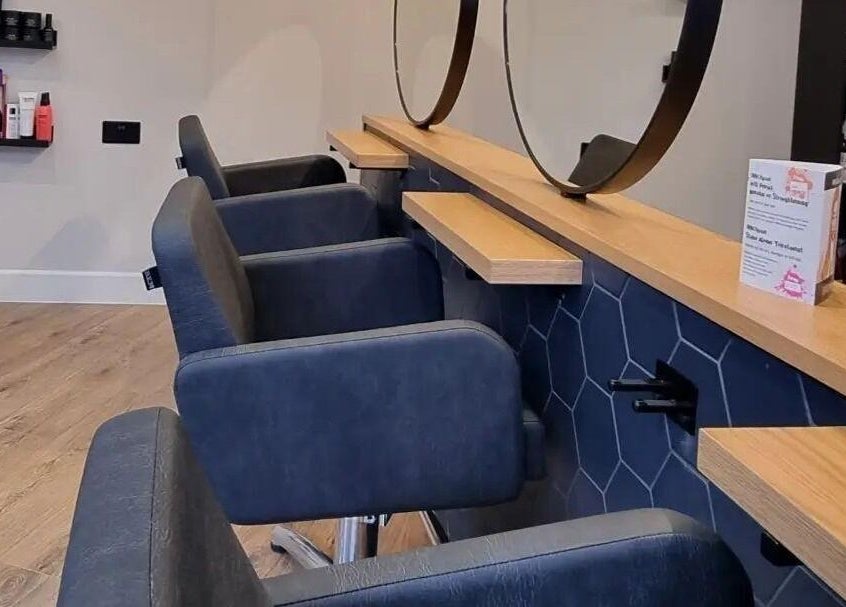 Modern salon interior with chairs at Onesixeight, Boston Spa, England, GB. Inviting and stylish atmosphere.