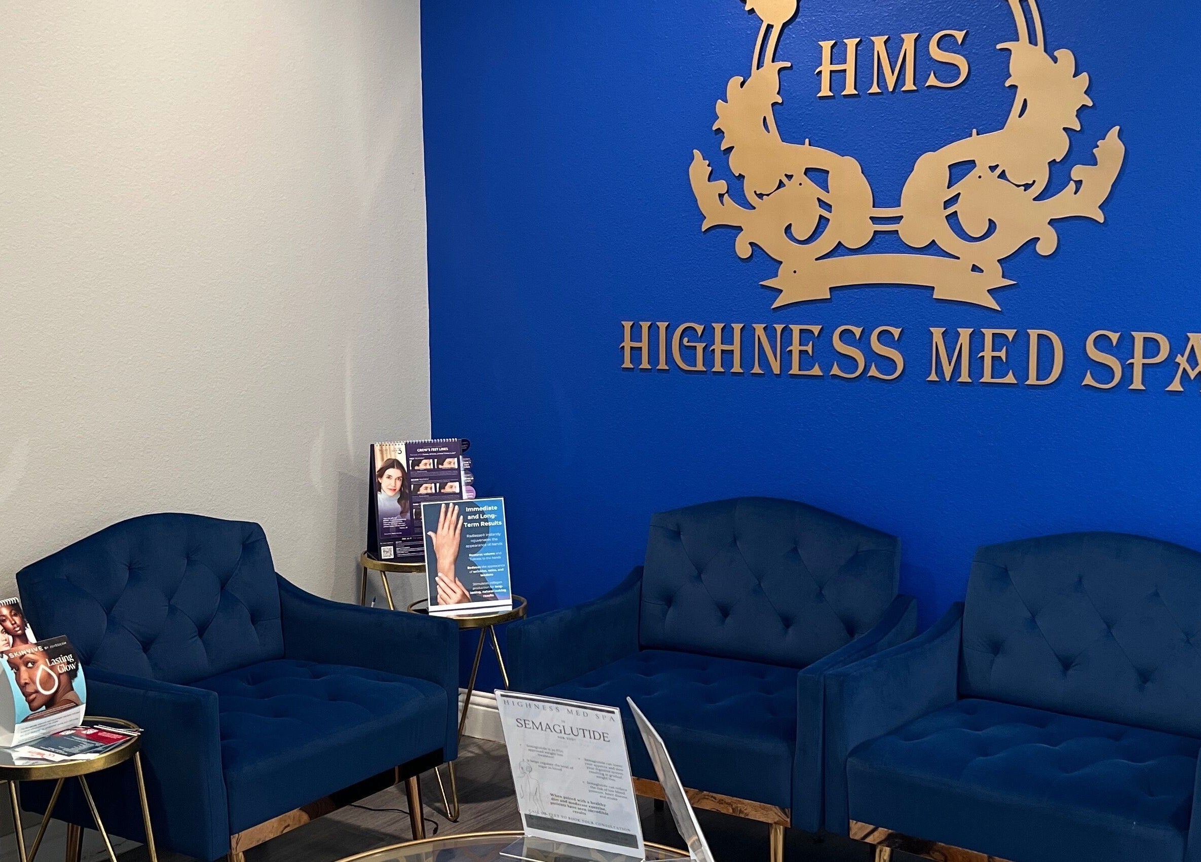 Elegant waiting area with blue seating at Highness Med Spa, Allen, Texas, US., showcasing luxury and comfort.