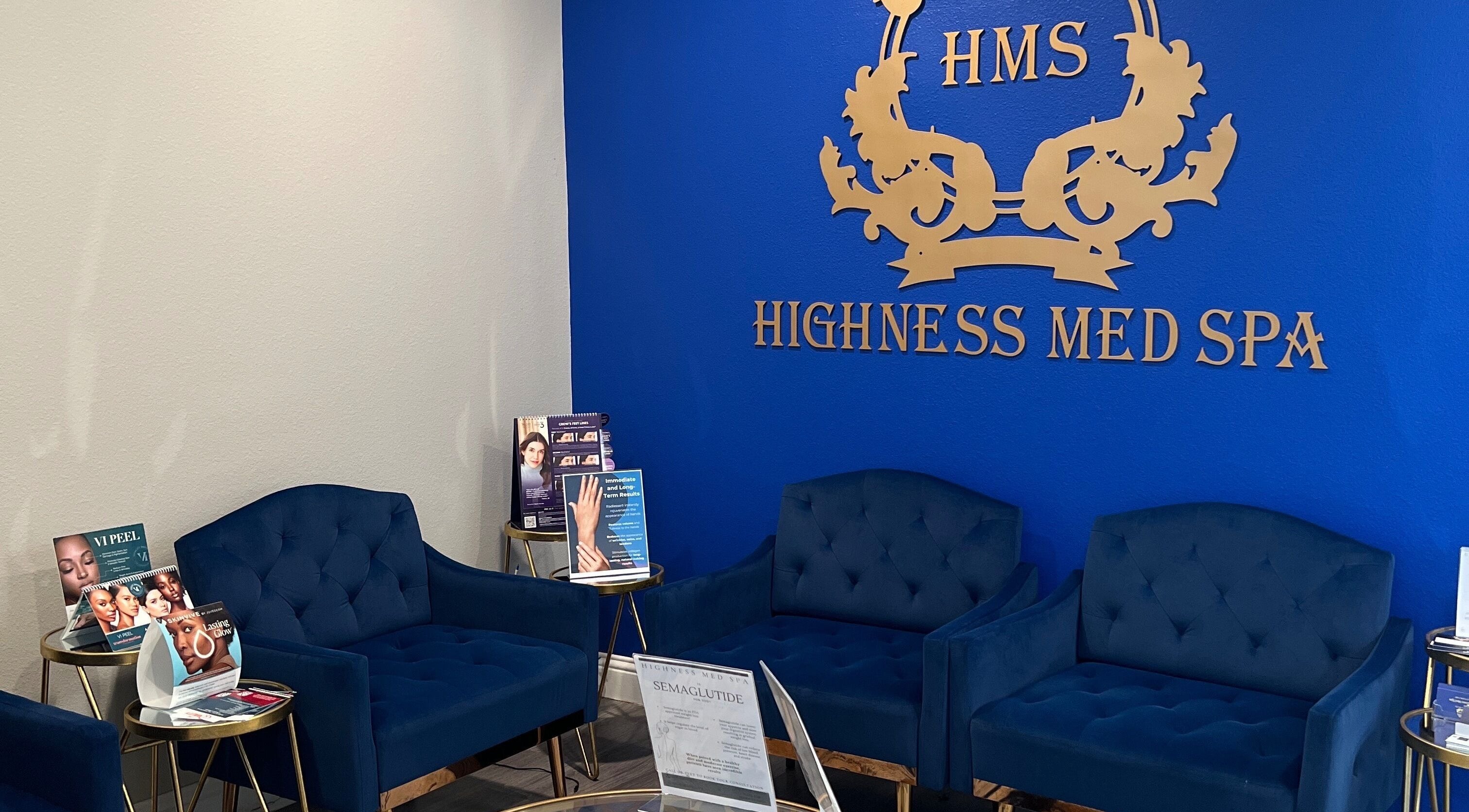 Elegant waiting area with blue seating at Highness Med Spa, Allen, Texas, US., showcasing luxury and comfort.
