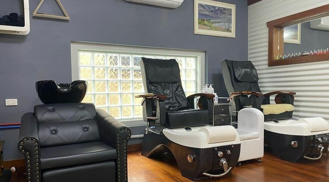 Salon Narooma's stylish pedicure station in Narooma, New South Wales, AU, featuring luxurious black chairs.