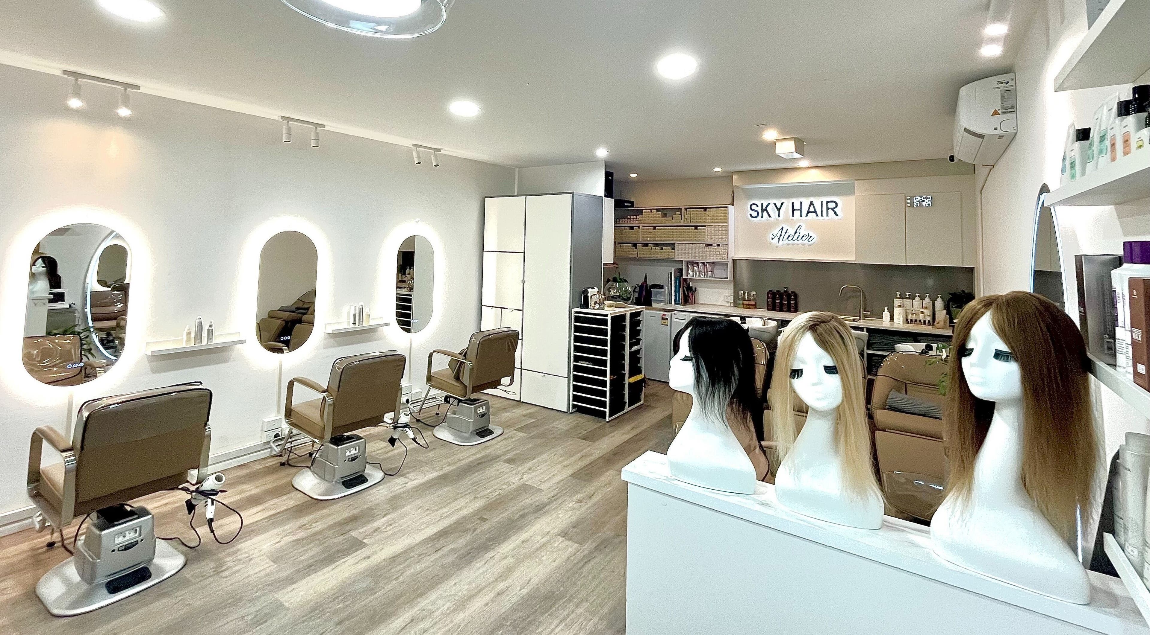 Modern interior of SKY HAIR ATELIER, Strathfield, New South Wales, AU with stylish seating and hair mannequins.
