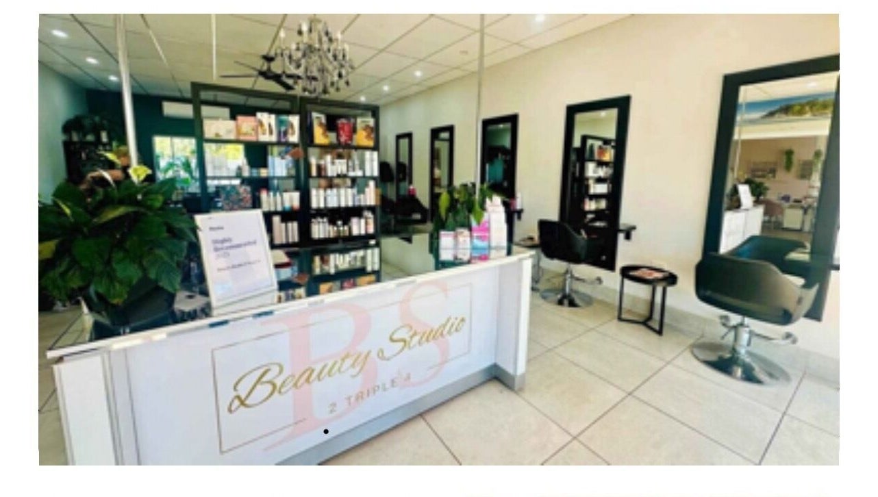 Elegant interior of Hairageous salon in Port Macquarie, New South Wales, AU, showcasing modern chairs and products.