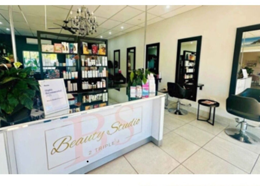 Elegant interior of Hairageous salon in Port Macquarie, New South Wales, AU, showcasing modern chairs and products.