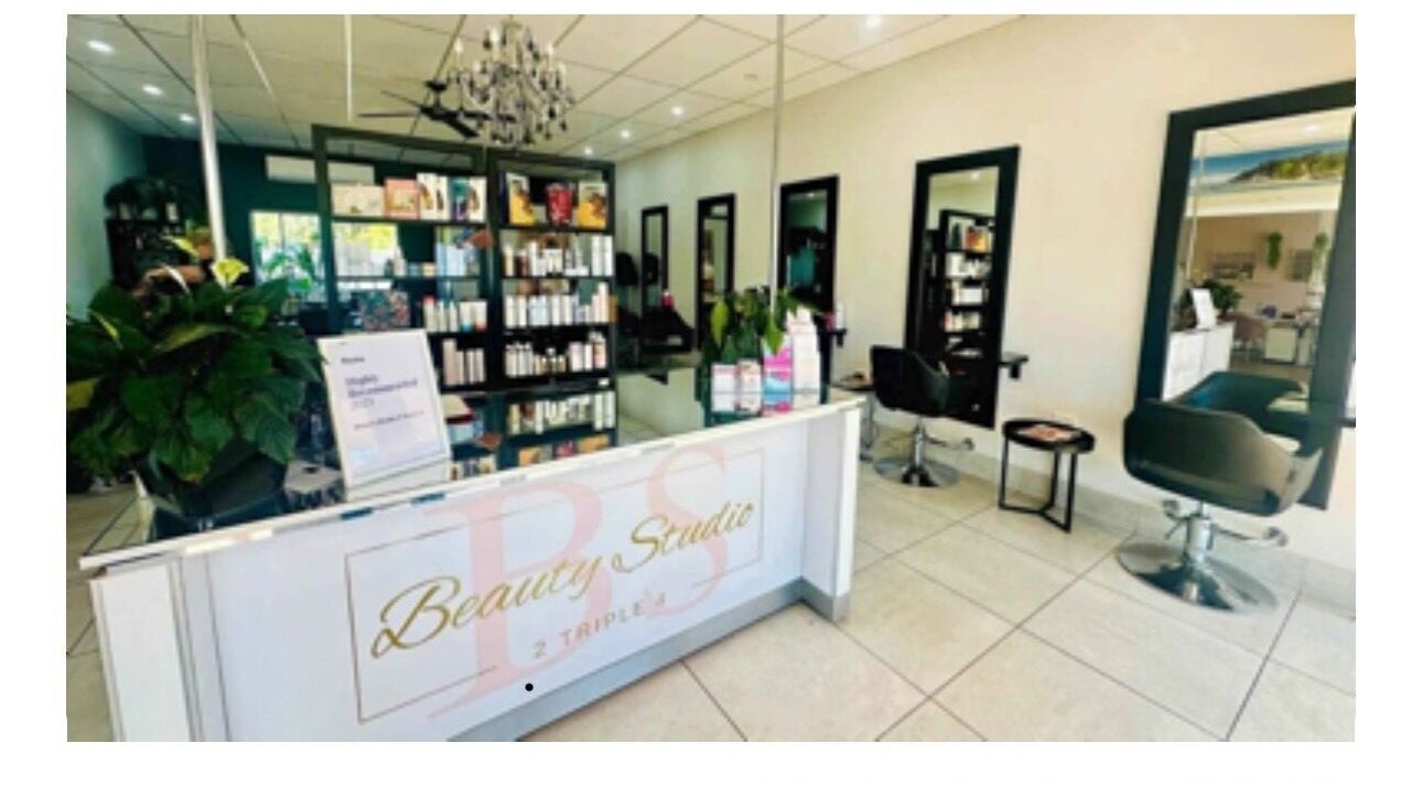 Elegant interior of Hairageous salon in Port Macquarie, New South Wales, AU, showcasing modern chairs and products.