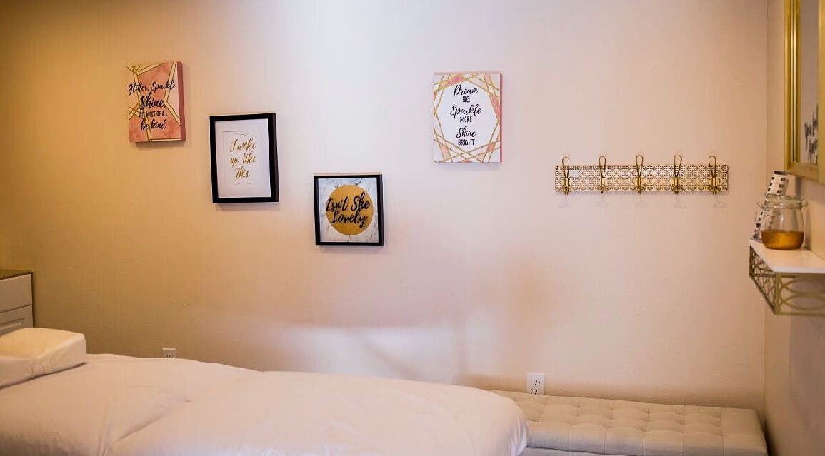 Tranquil treatment room at Allure Aesthetics, Great Falls, Montana, US, featuring elegant decor and soft linens.