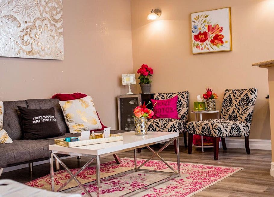 Cozy chic lounge at Allure Aesthetics, Great Falls, Montana, US, with floral decor and modern seating.