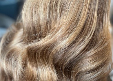 Shimmering golden blonde hair styled in soft waves at Eleanor Rose Hair, Accrington, England, GB.