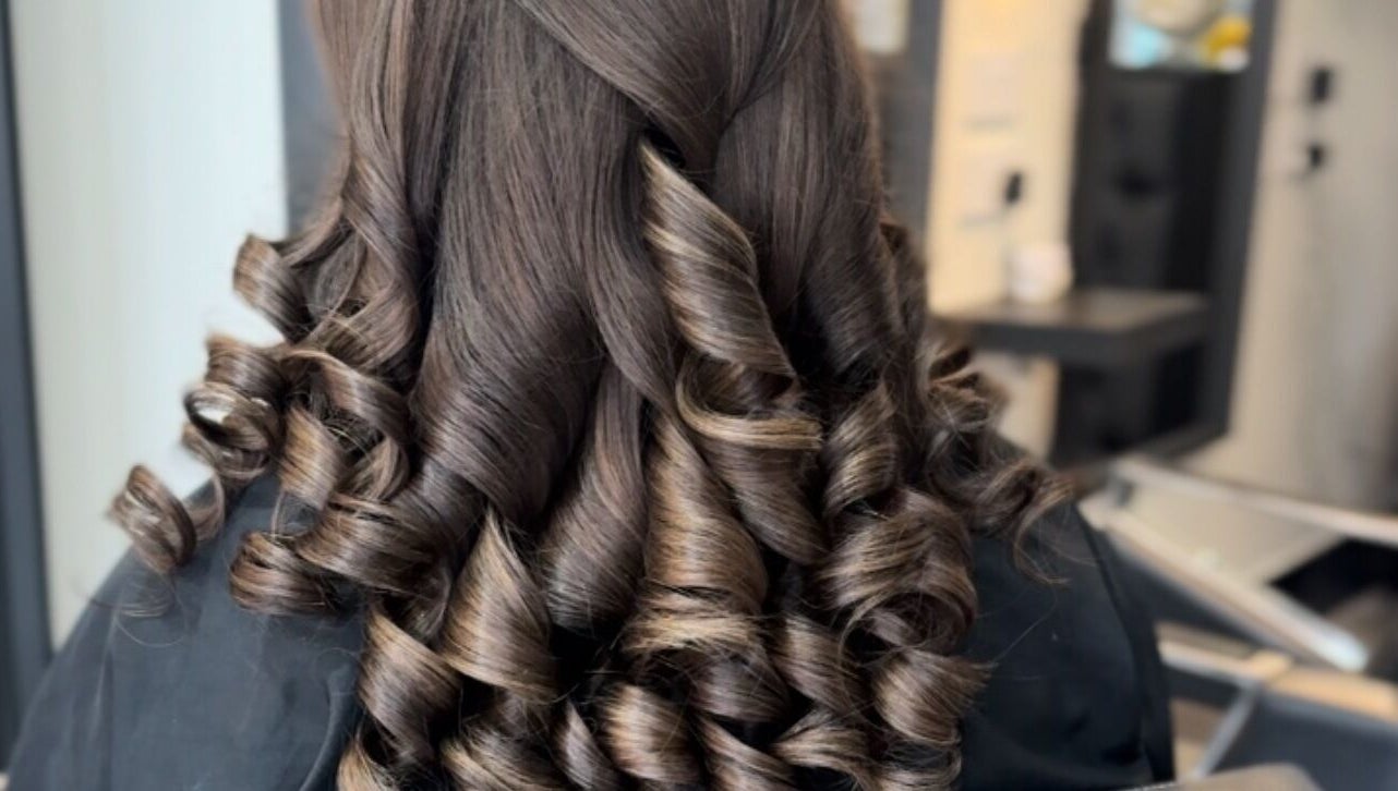 Elegant brown curls styled at Eleanor Rose Hair, Accrington, England, GB for a glamorous look.
