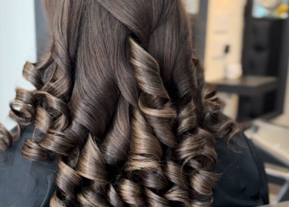 Elegant brown curls styled at Eleanor Rose Hair, Accrington, England, GB for a glamorous look.