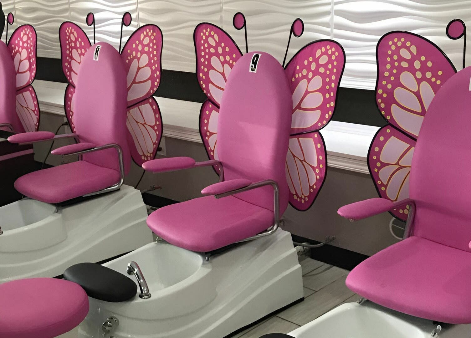 Butterfly-themed pedicure chairs at Rose Nails, Overland Park, Kansas, US, offer a whimsical spa experience.