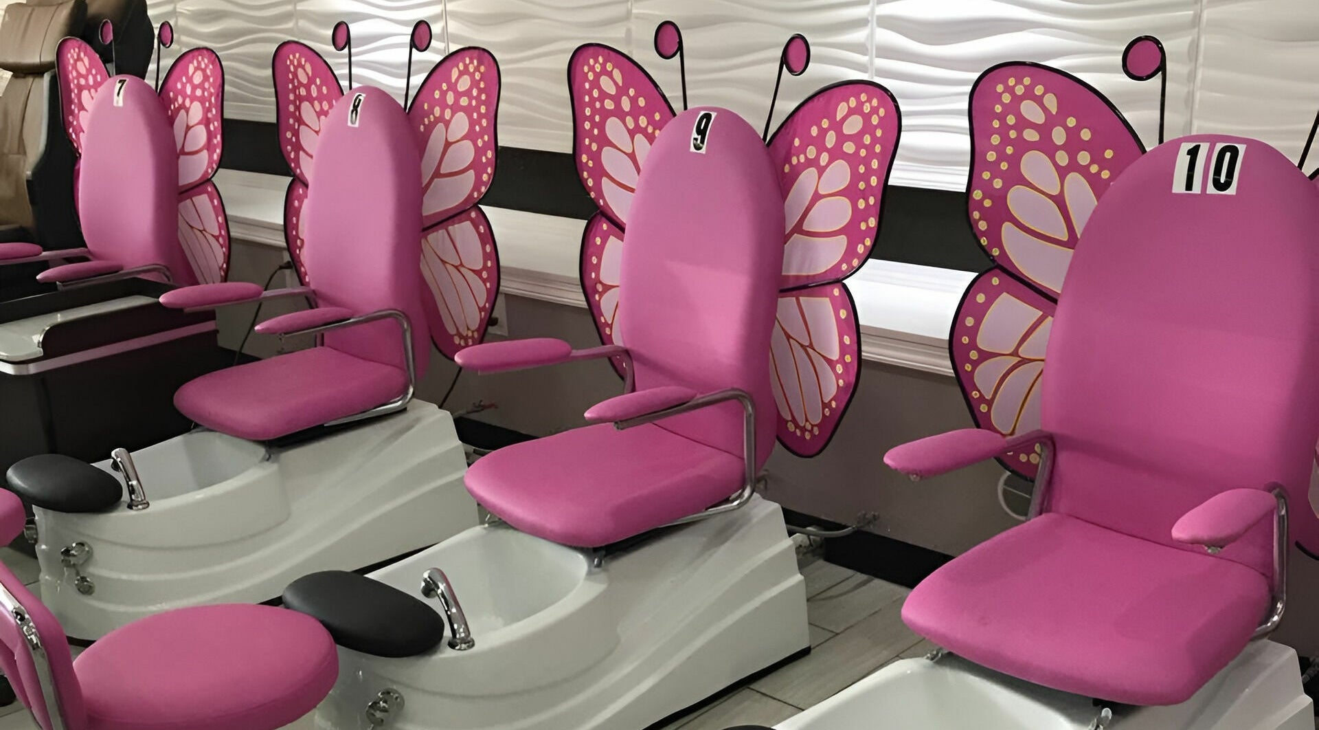 Butterfly-themed pedicure chairs at Rose Nails, Overland Park, Kansas, US, offer a whimsical spa experience.