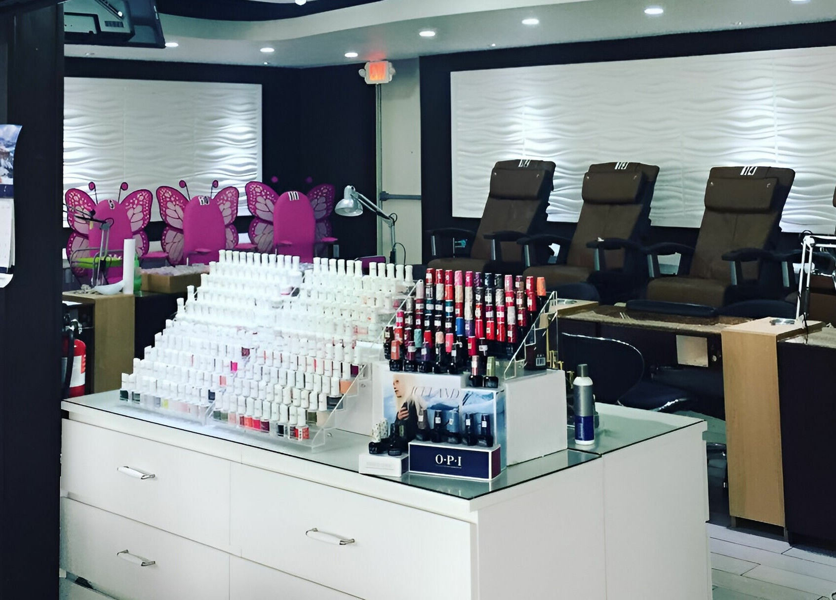 Rose Nails salon in Overland Park, Kansas features a stylish interior with vibrant colors and organized nail polishes.