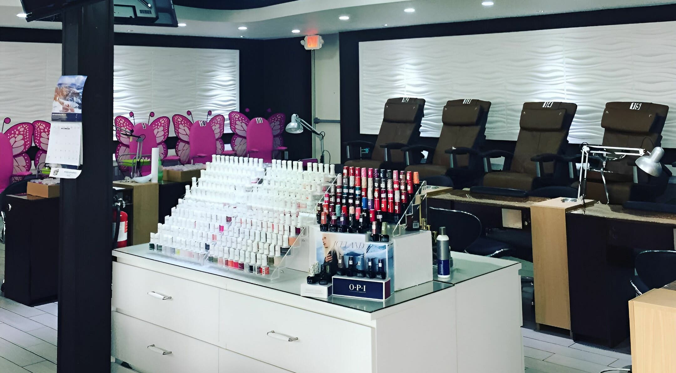 Rose Nails salon in Overland Park, Kansas features a stylish interior with vibrant colors and organized nail polishes.