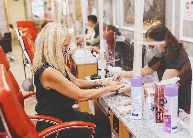 Client enjoys nail treatment at Rose Nails, Overland Park, Kansas, US. Modern, clean salon vibe.