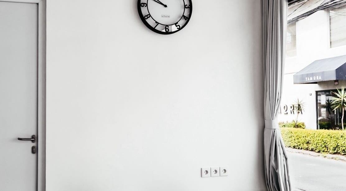 Modern interior at LASER ME ULUWATU, Bali, Bali, ID, featuring a wall clock and a view outside.