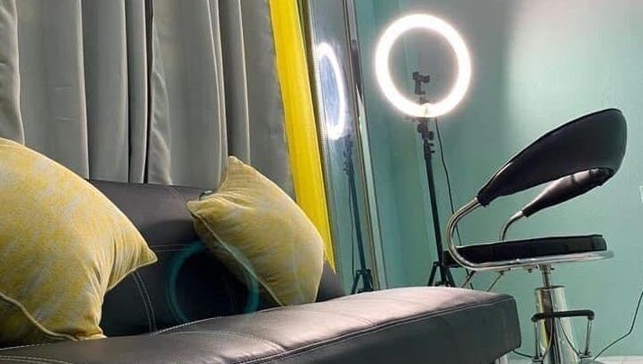 Cozy lounge area with stylish lighting at Savoir Beauty Ltd, Point Fortin, TT.