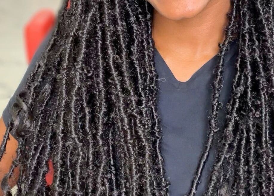 Close-up of intricate locs hairstyle at Savoir Beauty Ltd, Point Fortin, TT, showcasing expert styling.