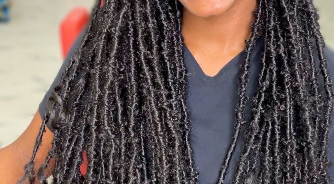 Close-up of intricate locs hairstyle at Savoir Beauty Ltd, Point Fortin, TT, showcasing expert styling.