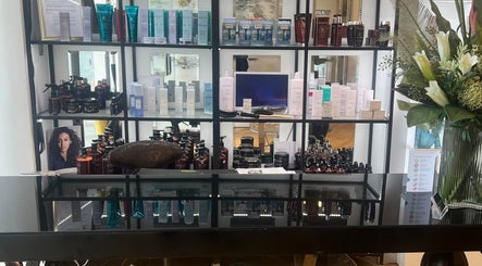 TOQQA Hair Salon in London displays luxurious hair care products on sleek shelves.