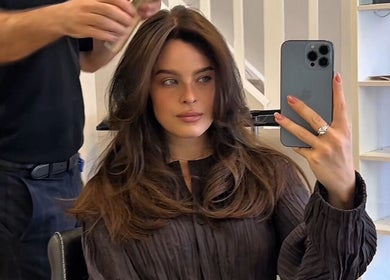 Woman capturing her new hairstyle at TOQQA Hair Salon, London, England, GB.