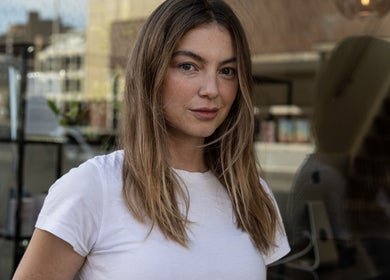 A stylish woman's portrait outside TOQQA Hair Salon in London, England, GB.