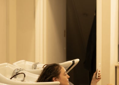 Visitor enjoys a relaxing hair wash at TOQQA Hair Salon, London, England, GB.