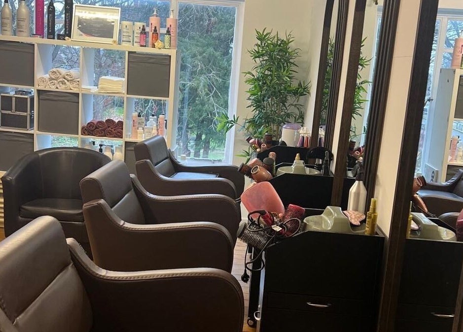 Chic and inviting salon interior at Models Hair & Beauty, Colchester, England, GB, showcasing stylish seating.