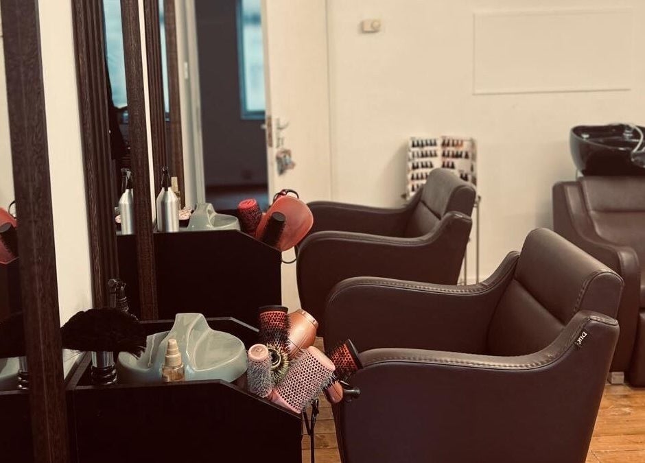 Chic interior of Models Hair & Beauty salon in Colchester, England, GB, featuring sleek styling chairs and mirrors.