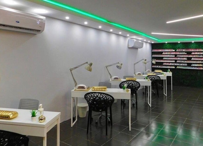 Interior moderno de Cortauñas Salón en Carolina, US mostrando mesas de manicura y decoración elegante.