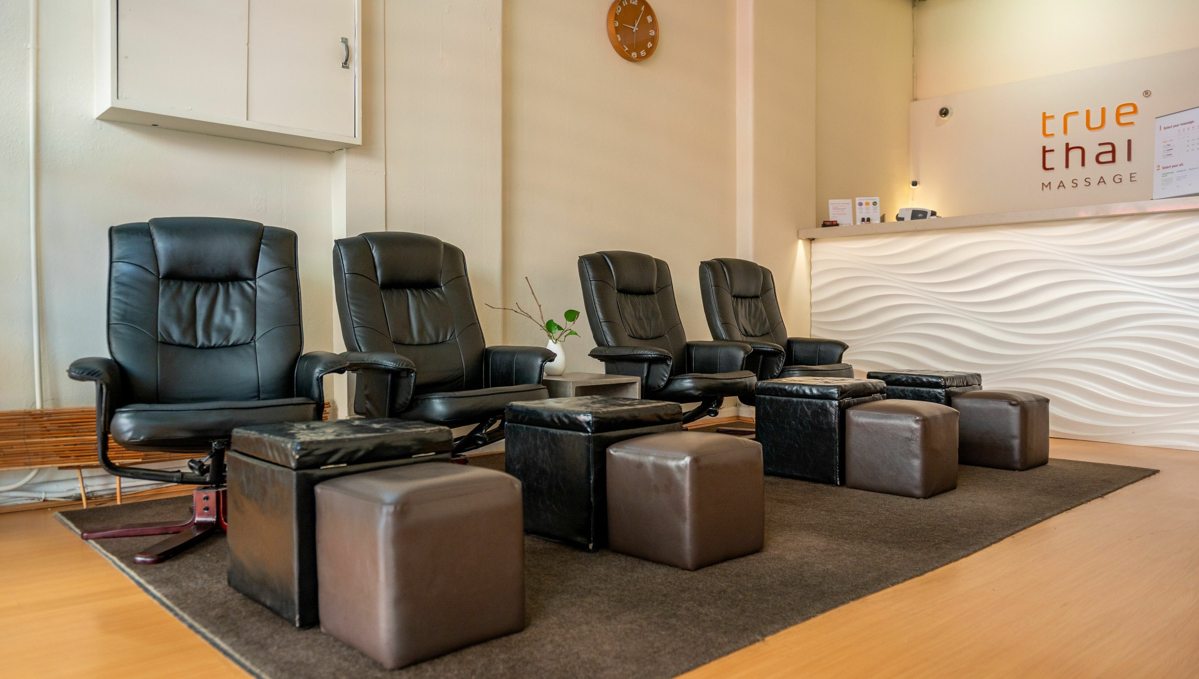 Comfortable black chairs and footrests at Prahran - True Thai Massage, Prahran, VIC, AU.