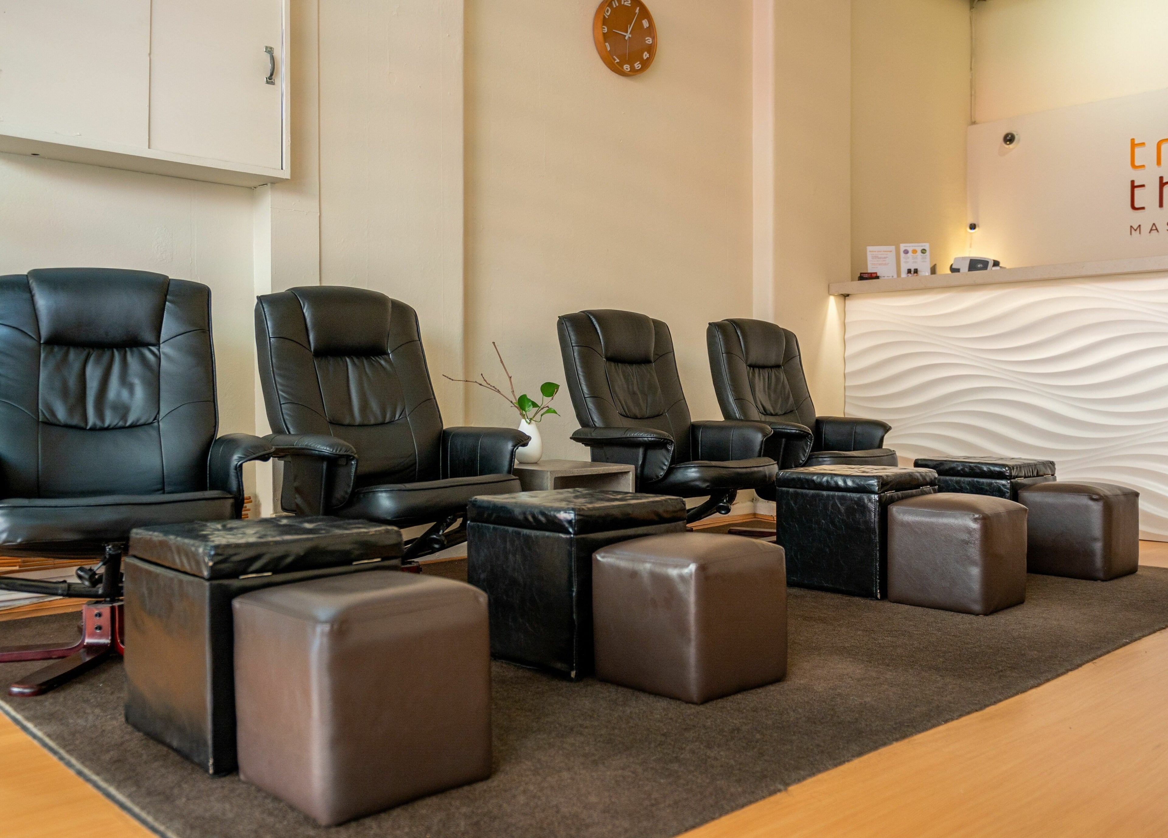 Comfortable black chairs and footrests at Prahran - True Thai Massage, Prahran, VIC, AU.