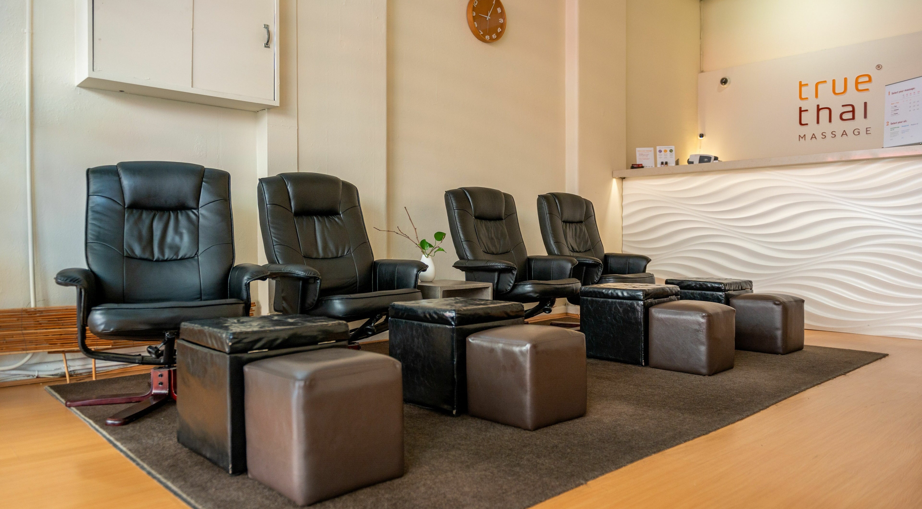 Comfortable black chairs and footrests at Prahran - True Thai Massage, Prahran, VIC, AU.