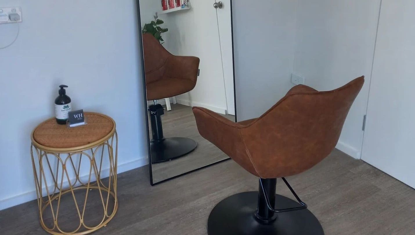 Elegant salon chair and mirror at Whyte Hair, Taroomball, Queensland, AU, reflecting a modern salon vibe.