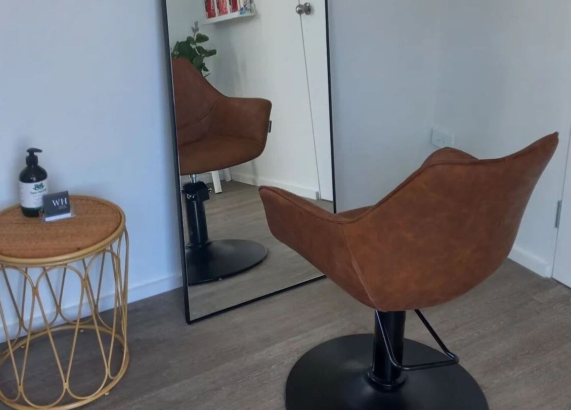 Elegant salon chair and mirror at Whyte Hair, Taroomball, Queensland, AU, reflecting a modern salon vibe.
