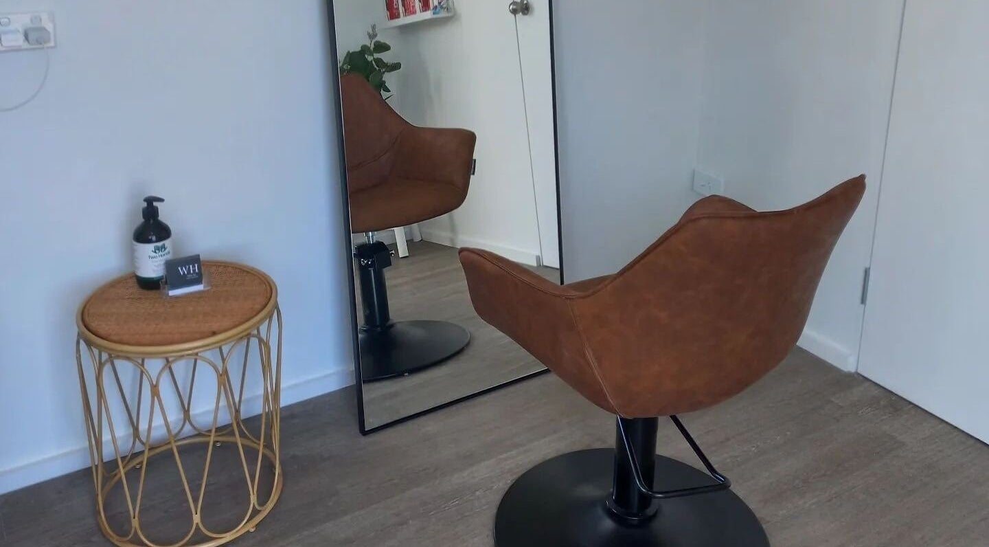 Elegant salon chair and mirror at Whyte Hair, Taroomball, Queensland, AU, reflecting a modern salon vibe.