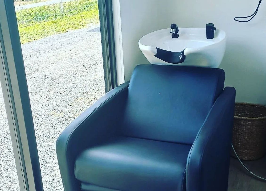 Comfortable hair washing chair at Whyte Hair in Taroomball, Queensland, AU with serene outdoor view.