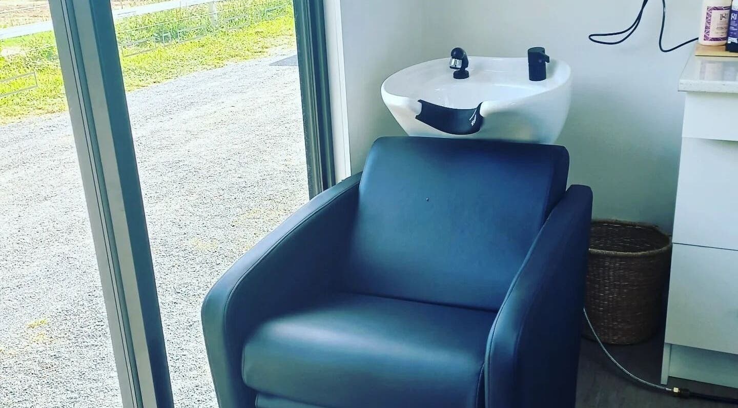 Comfortable hair washing chair at Whyte Hair in Taroomball, Queensland, AU with serene outdoor view.