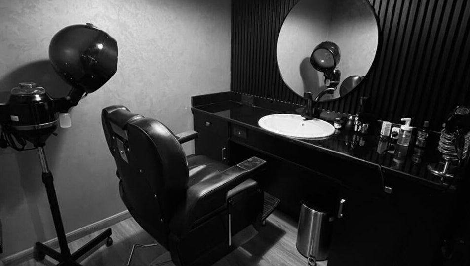 Modern hair styling station at Dark Candles Saloon in Abu Dhabi, Abu Dhabi, AE featuring sleek decor.