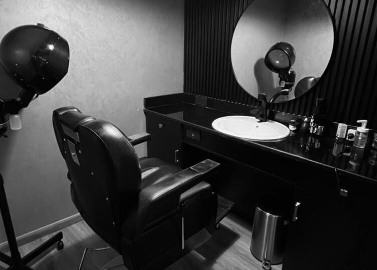 Modern hair styling station at Dark Candles Saloon in Abu Dhabi, Abu Dhabi, AE featuring sleek decor.