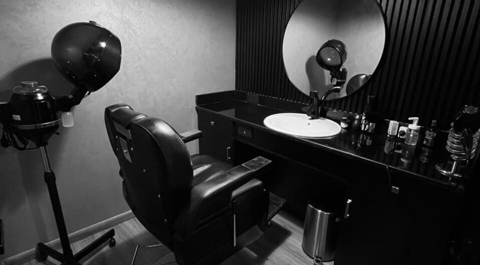 Modern hair styling station at Dark Candles Saloon in Abu Dhabi, Abu Dhabi, AE featuring sleek decor.