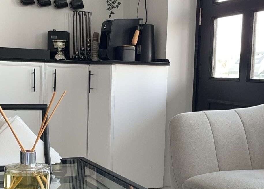 Modern lounge area at Dark Candles Saloon, Abu Dhabi, AE featuring elegant decor and aromatic diffusers.