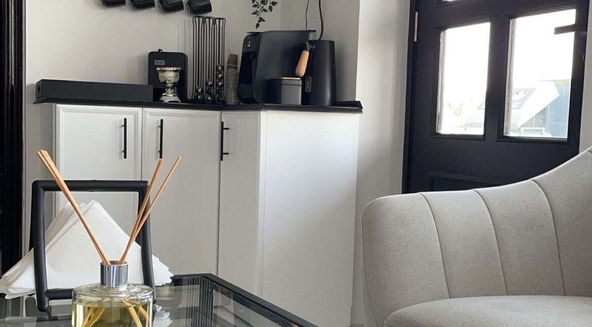 Modern lounge area at Dark Candles Saloon, Abu Dhabi, AE featuring elegant decor and aromatic diffusers.