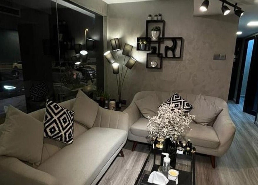 Elegant seating area in Dark Candles Saloon, Abu Dhabi, AE, featuring plush sofas and stylish decor.