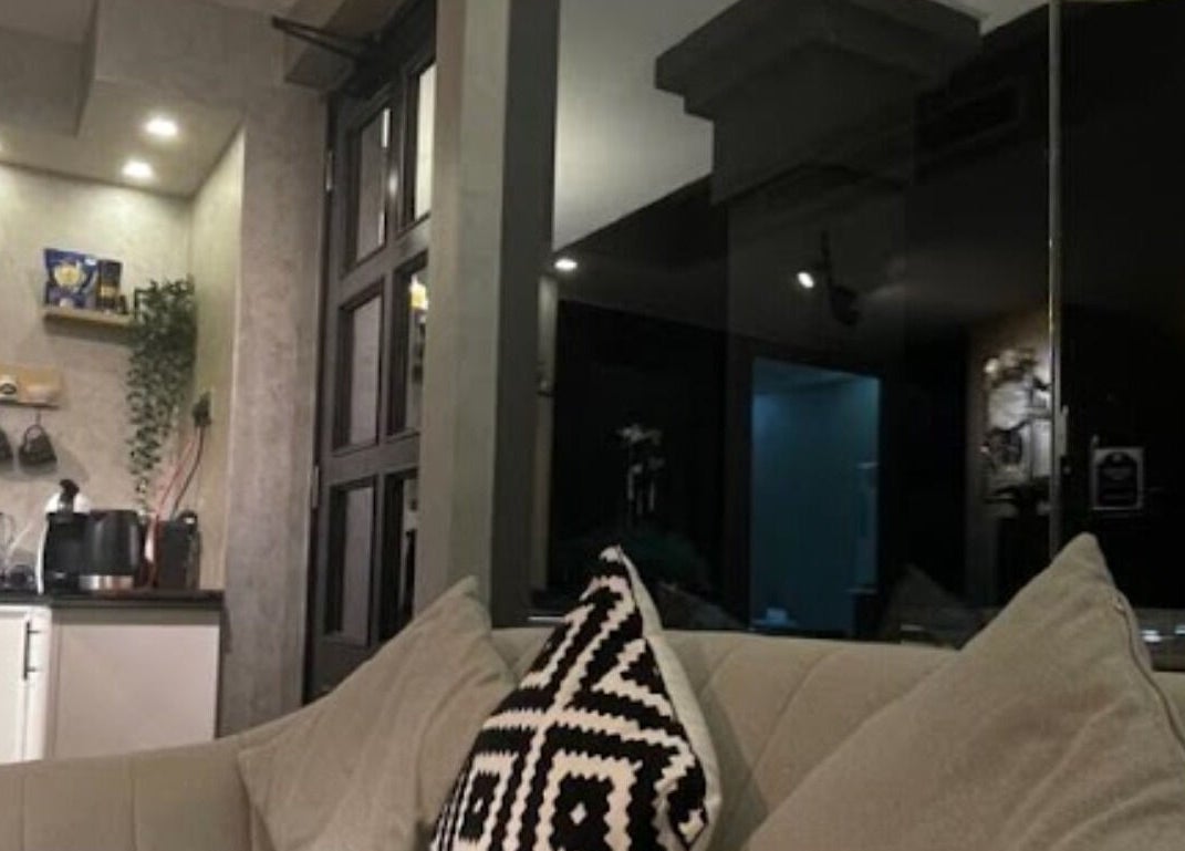 Stylish interior of Dark Candles Saloon, Abu Dhabi, AE featuring plush seating and ambient lighting.