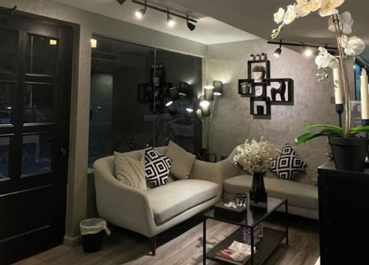 Elegant lounge at Dark Candles Saloon, Abu Dhabi, AE, featuring plush seating and ambient lighting.